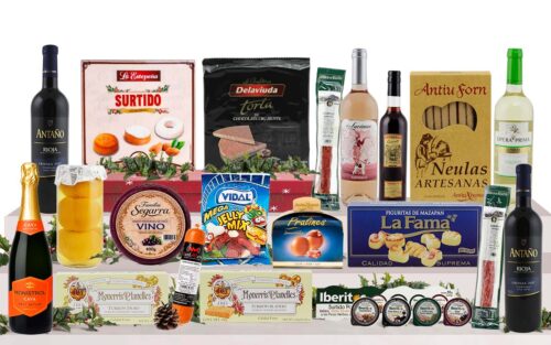 Lot nadalenc amb cava, vi blanc, vi negre, neules artesanes, torrons variats, galetes assortides, bombons, llaminadures, embotit i crema per untar, presentat com a regal de Nadal.