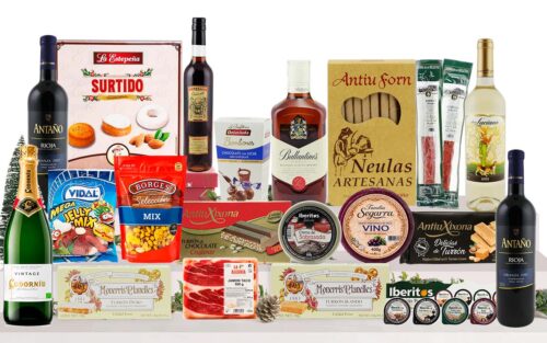 Lot nadalenc premium amb cava, vins, whisky, vermut, formatge, pernil, embotits ibèrics, fruits secs, patés, torrons, neules, bombons, dolços nadalencs i llaminadures, presentat en una caixa de cartró decorada.