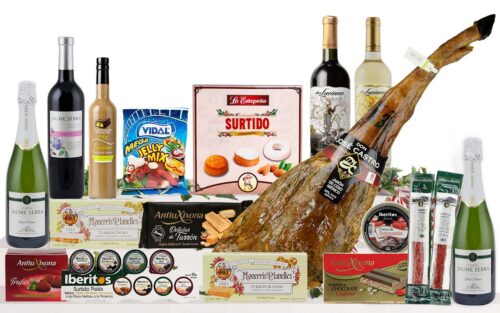 Lot nadalenc premium amb pernil curat, cava, vins, vermut, patés, torrons, neules, embotits, llaminadures i dolços tradicionals, presentat com a regal de Nadal.