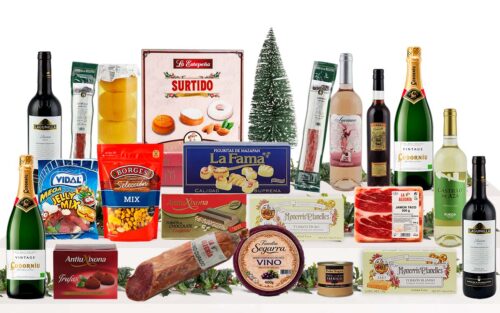 Lot nadalenc gourmet amb pernil curat, cava, vins, vermut, formatge, embotits ibèrics, fruits secs, patates xips, patés, torrons, neules, bombons, dolços nadalencs i llaminadures, presentat com a regal de Nadal.