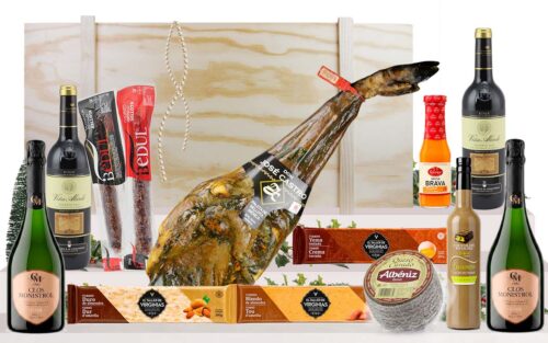 Lot gourmet amb paleta ibèrica de gla de Guijuelo, cava, vins, embotits ibèrics, formatge, torrons i licor, presentat en una caixa jamonera de fusta.