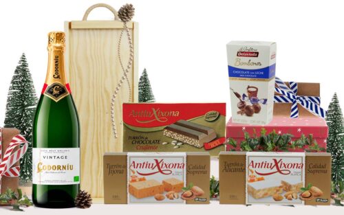Lot dolç amb cava Codorníu Vintage Brut Eco, torrons de Xixona, Alacant i xocolata cruixent, bombons de xocolata amb llet, presentat en una caixa de fusta amb nansa.